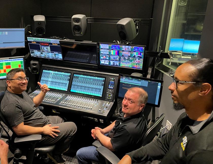Space City Home Network crew in front of a SSL mixing board.