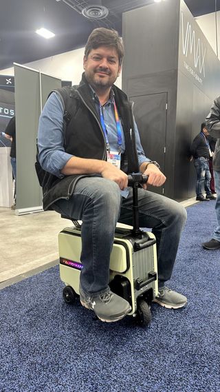 TG's Mike Prospero riding a suitcase at CES 2025