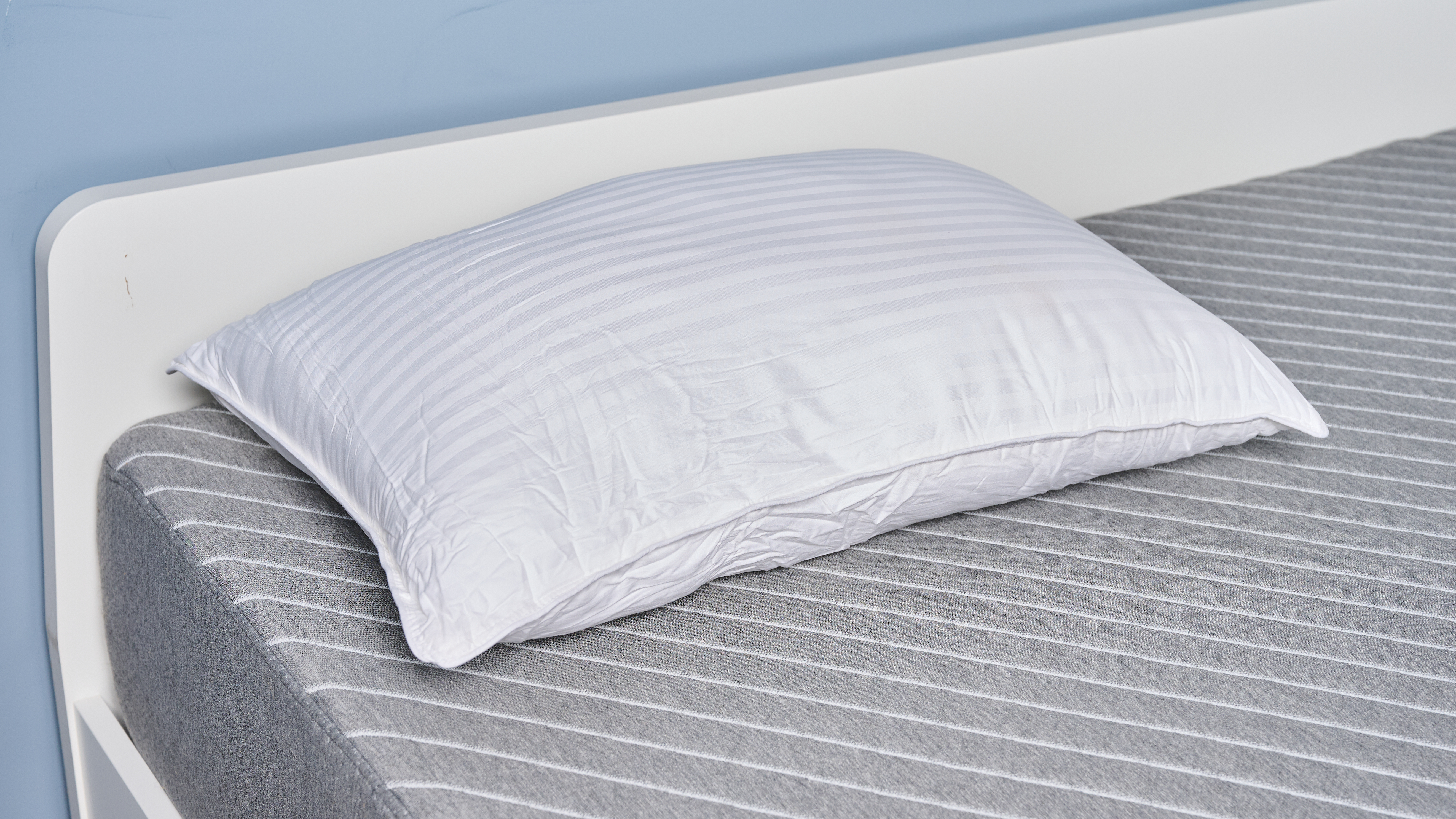 Beckham Hotel Collection Down-Alternative Pillow placed on the bed near the headboard