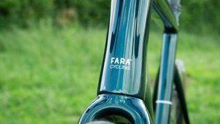 A close up of the Fara F/AR bike standing in a field