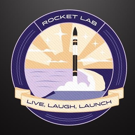 A mission patch shows a black and white rocket launching over a beach