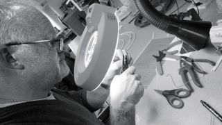 A bearded man making a Chord Company cable by hand.