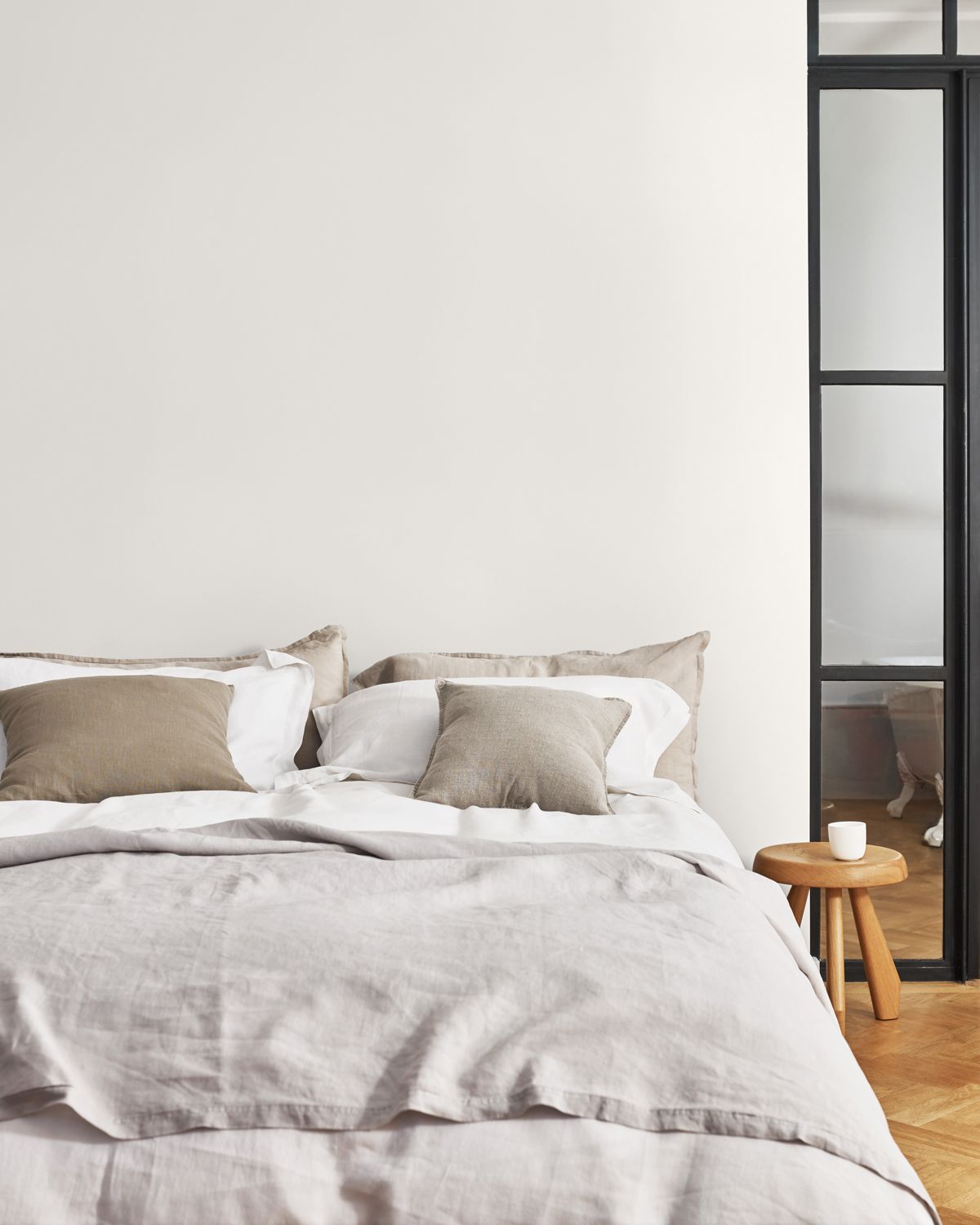 Cool white paint color on bedroom walls behind bed