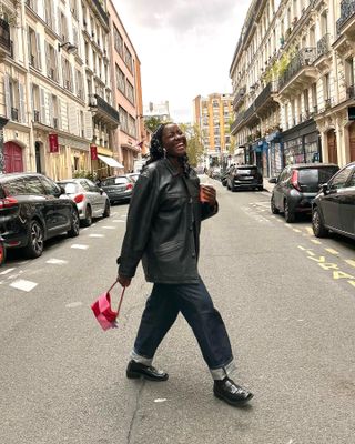 Fashion influencer @raissatch in Paris wearing a polished outfit with jeans and loafers.