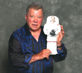 ‘Star Trek’ star William Shatner poses with a 2-D image of Canadian astronaut Chris Hadfield as part of a photo contest run by the Canadian Space Agency to promote the spaceflyer’s upcoming mission.