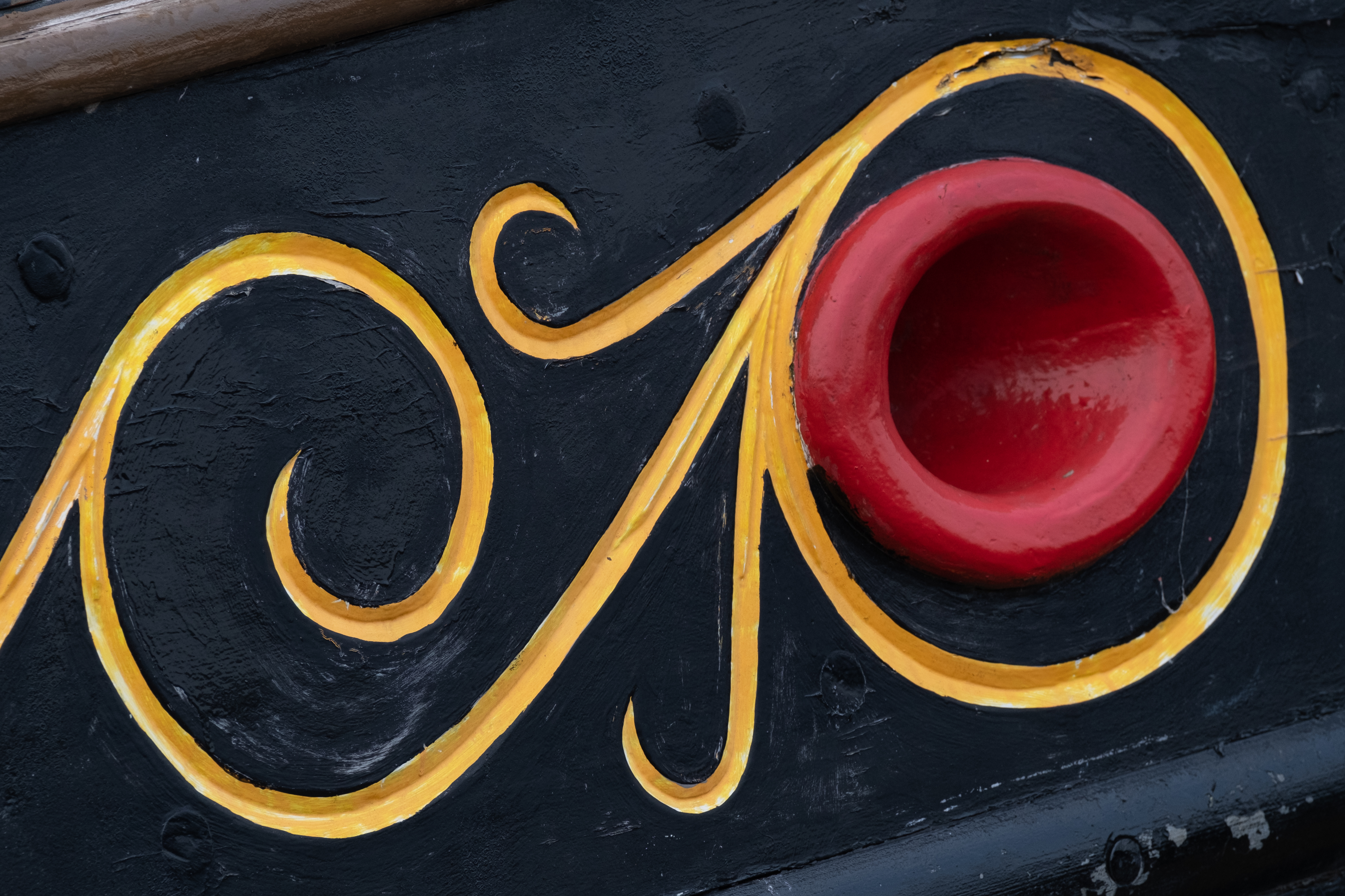 A yellow pattern detail on a ship's hull