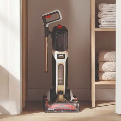 Shark CarpetForce Upright Carpet Cleaner with the wand removed for easy storage in the corner of a room