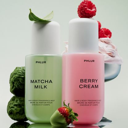 Phlur matcha milk and berry cream body mists with ingredients on green gradient background