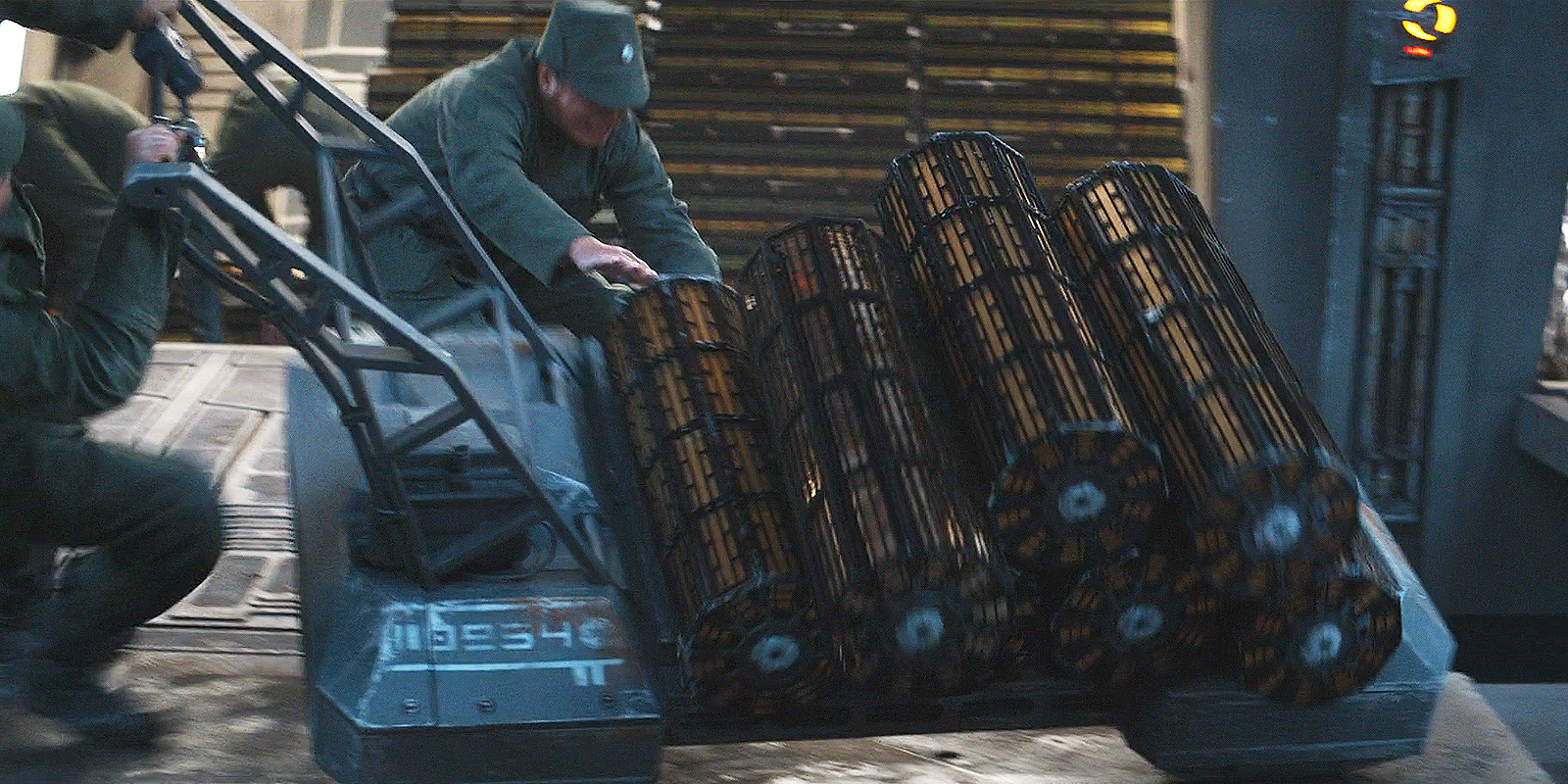 A still from Andor episode 6 showing Imperial officers loading pallets of credits onto a freighter.