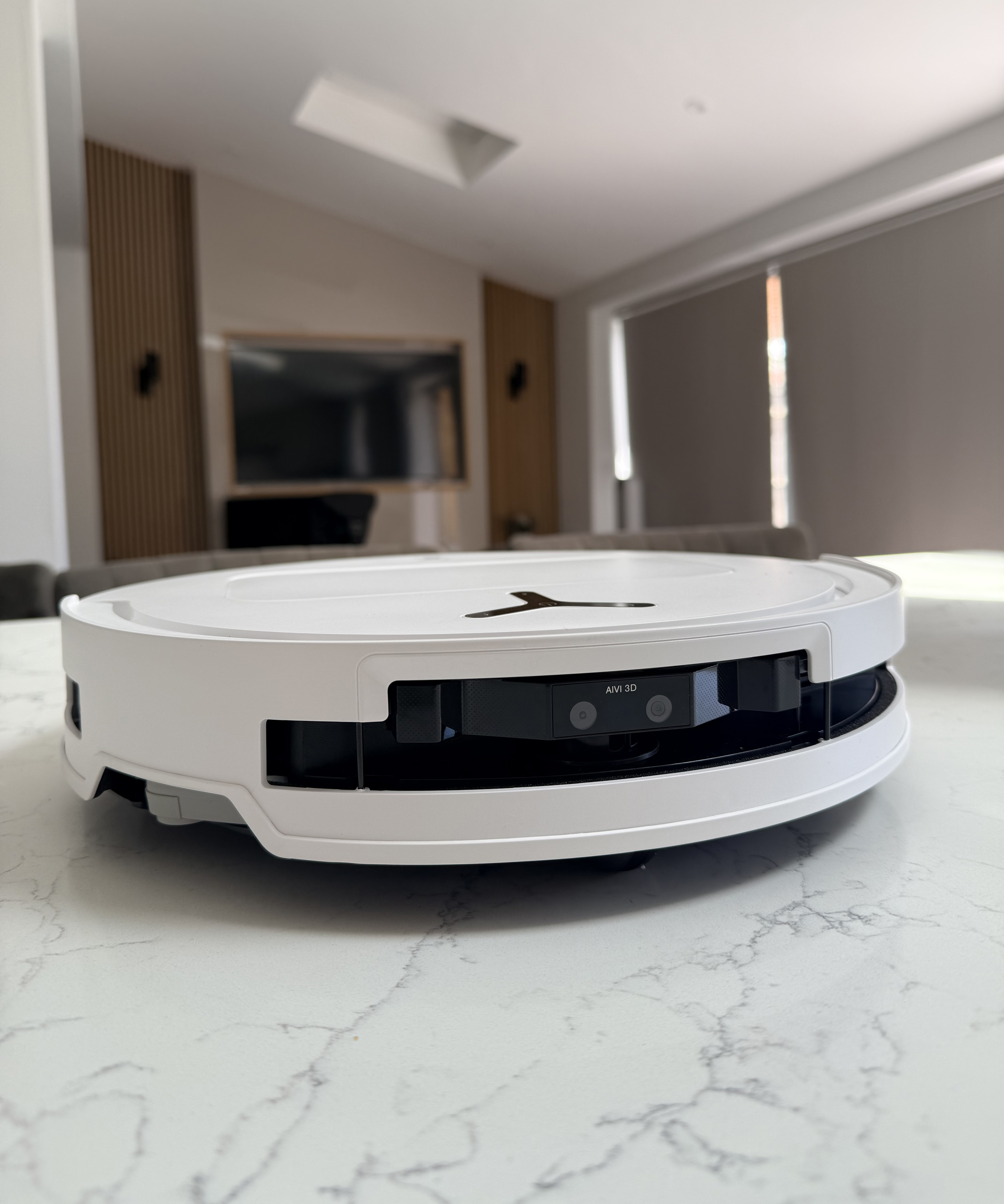 Low side profile of the Ecovacs Deebot T50 Pro Omni robot vacuum on a kitchen countertop