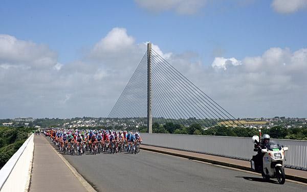 The Tour peloton crosses a bridge in Brest.