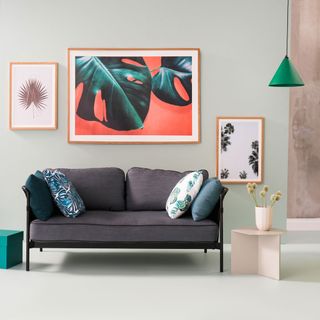 living room with photoframe on white wall and grey sofa set