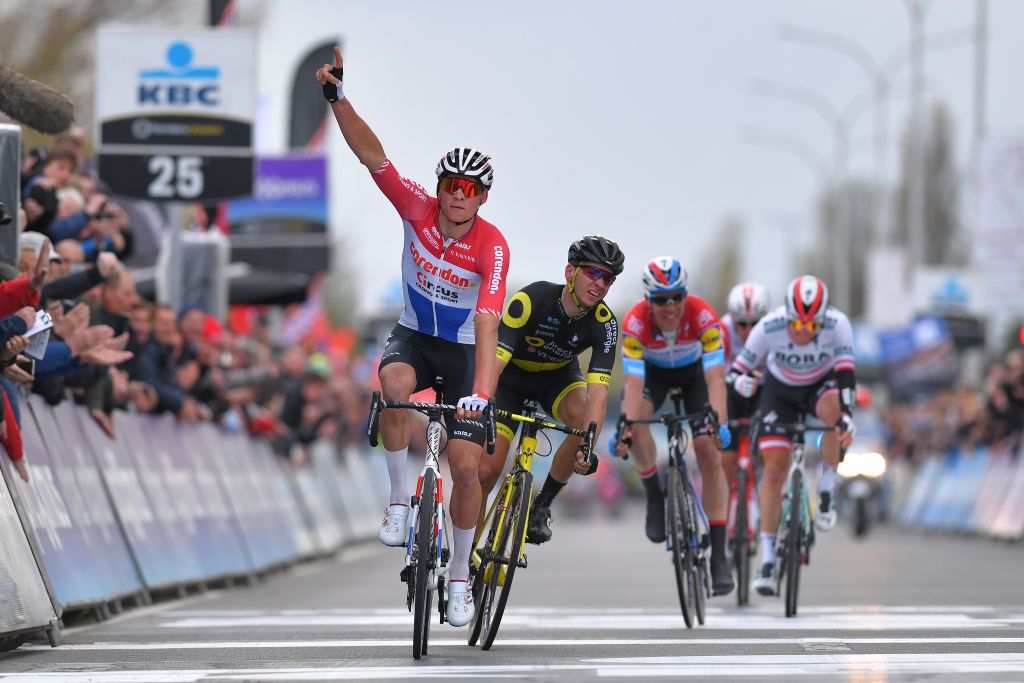 WAREGEM BELGIUM APRIL 03 Arrival Mathieu van der Poel of The Netherlands and Team CorendonCircus Celebration Anthony Turgis of France and Team Direct Energie Disappointment during the 74th Dwars door Vlaanderen 2019 a 1828km race from Roeselare to Waregem DwarsdrVlaander FlandersClassic on April 03 2019 in Waregem Belgium Photo by Tim de WaeleGetty Images