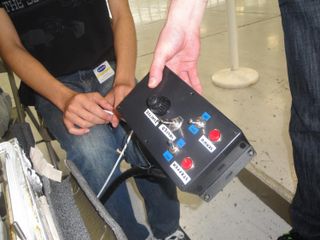 University of California, San Diego, aerospace engineering student Sam Avery demonstrates the control box for his team's zero-gravity flame experiment to ride on a weightless flight during NASA's Microgravity University Program at Ellington Field, Houston