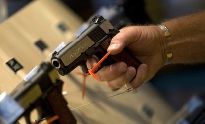 A man grips a gun at last year's National Rifle Association meeting.
