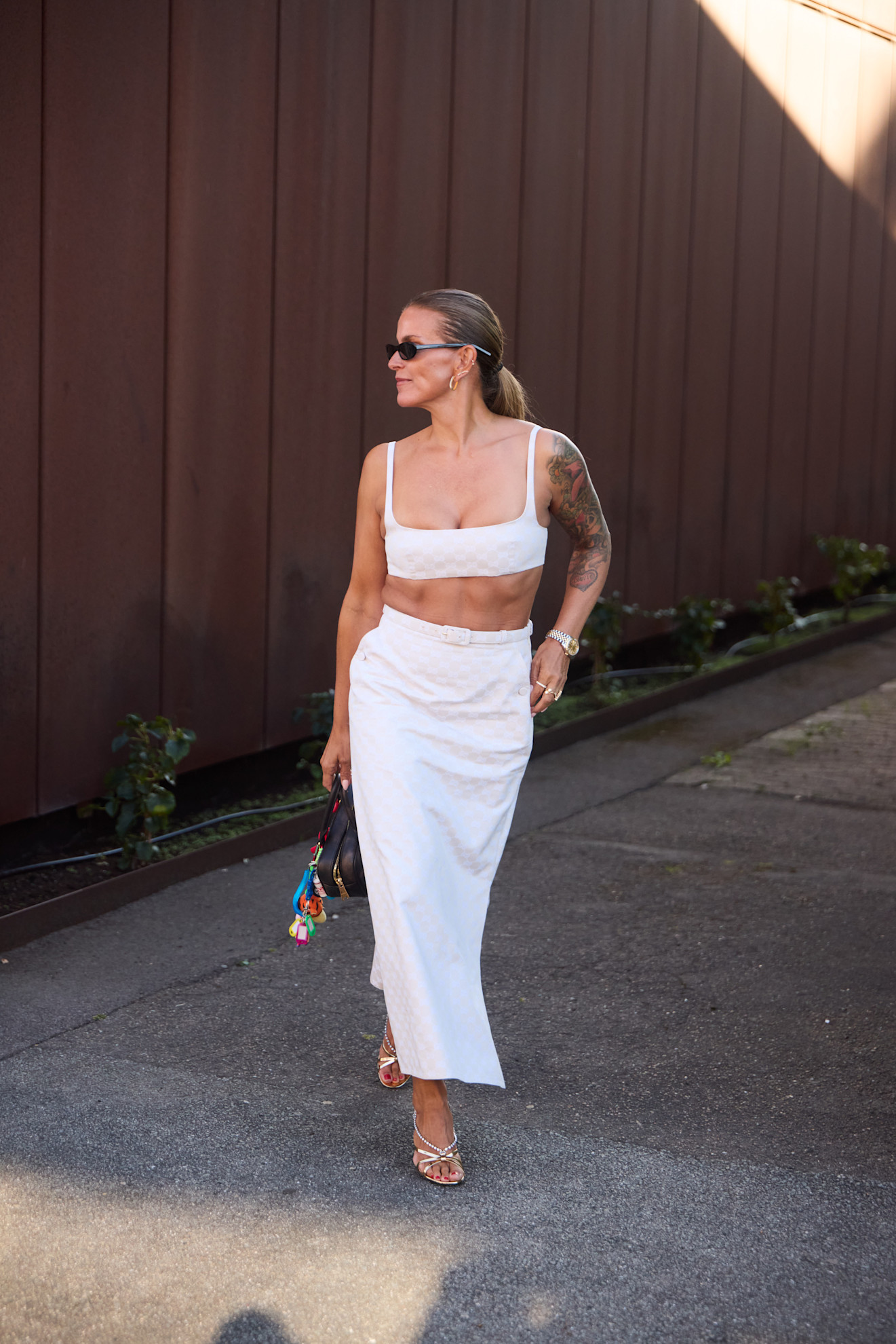 woman wearing a white bra top and a white pencil skirt in Copenhagen.