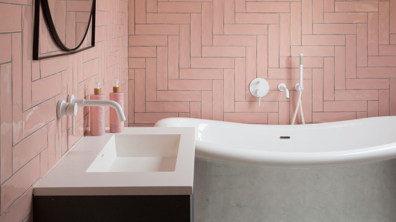 Pink bathroom tiles with bath and sink 