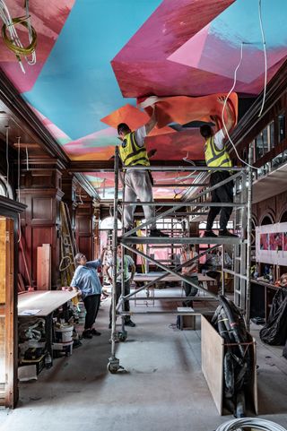 British artist Phyllida Barlow installing her ceiling installation in The Audley pub in Mayfair