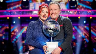 Chris and Dianne looking happy as they hold the glitterball trophy in their hands after winning Strictly Come Dancing 2024