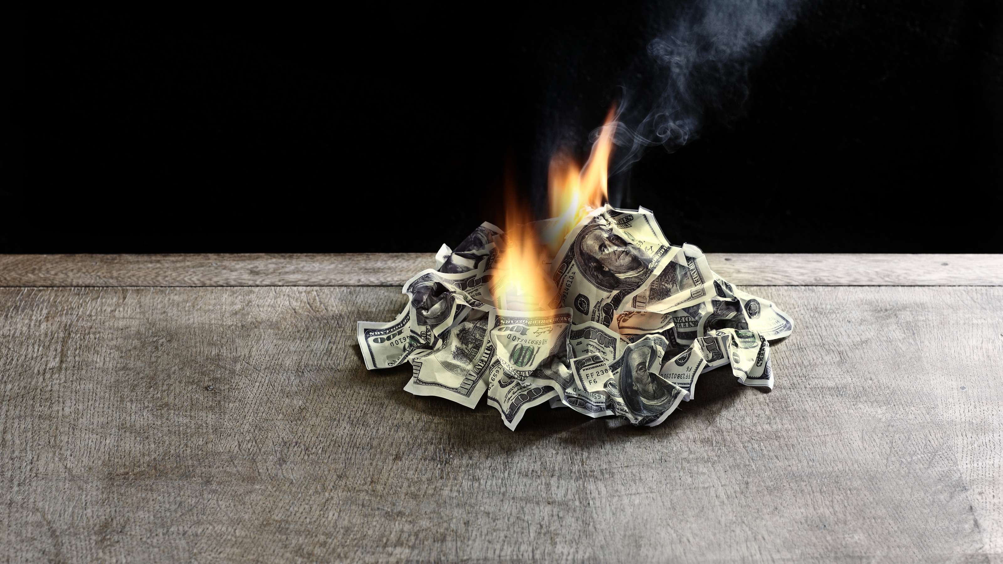 A pile of money is on fire.