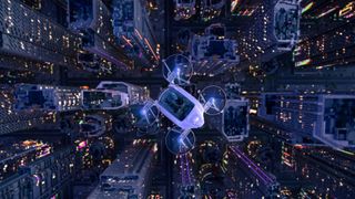 An illustration shows a flying car with four rotors flying over a tall city skyline