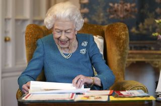 Queen Elizabeth II views a display of memorabilia from her Golden and Platinum Jubilees in the Oak Room at Windsor Castle