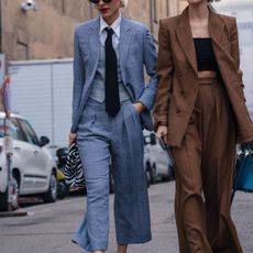 Milan, Italy - 20 February 2020: Stylish persons are posing for photographers before Max Mara fashion show on Milan Woman's Fashion Week F/W2020-2021, street style - stock photo