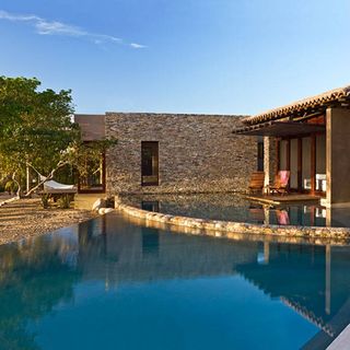 mexican retreat with swimming pool and lounge chairs