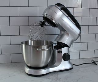 An open Hamilton Beach Stand Mixer with whisk attachment