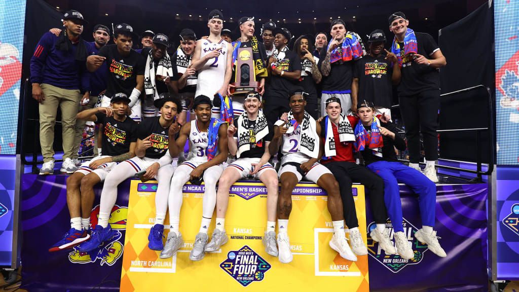 The Kansas Jayhawks pose for a photo after winning the 2022 NCAA men&amp;#039;s basketball tournament.