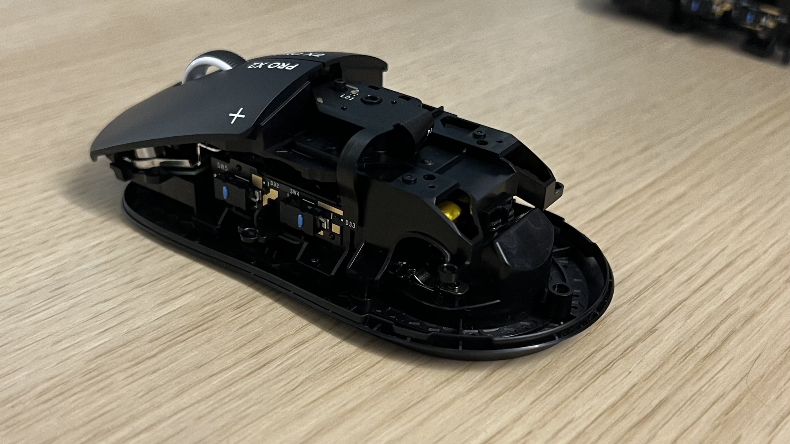 Logitech G Pro X2 Superstrike with main chassis removed on a wooden table