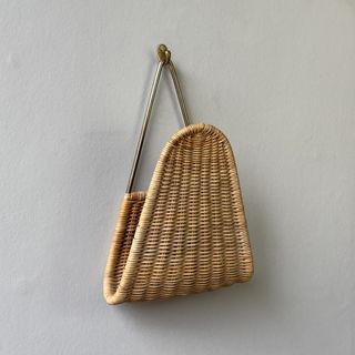 carl-aubock-ii-wall-mounted-brass-and-wicker-magazine-rack-curved-frame-mid-century-design-austria-modernist-modernism-1950s-vintage-woven-angle-view_1080x