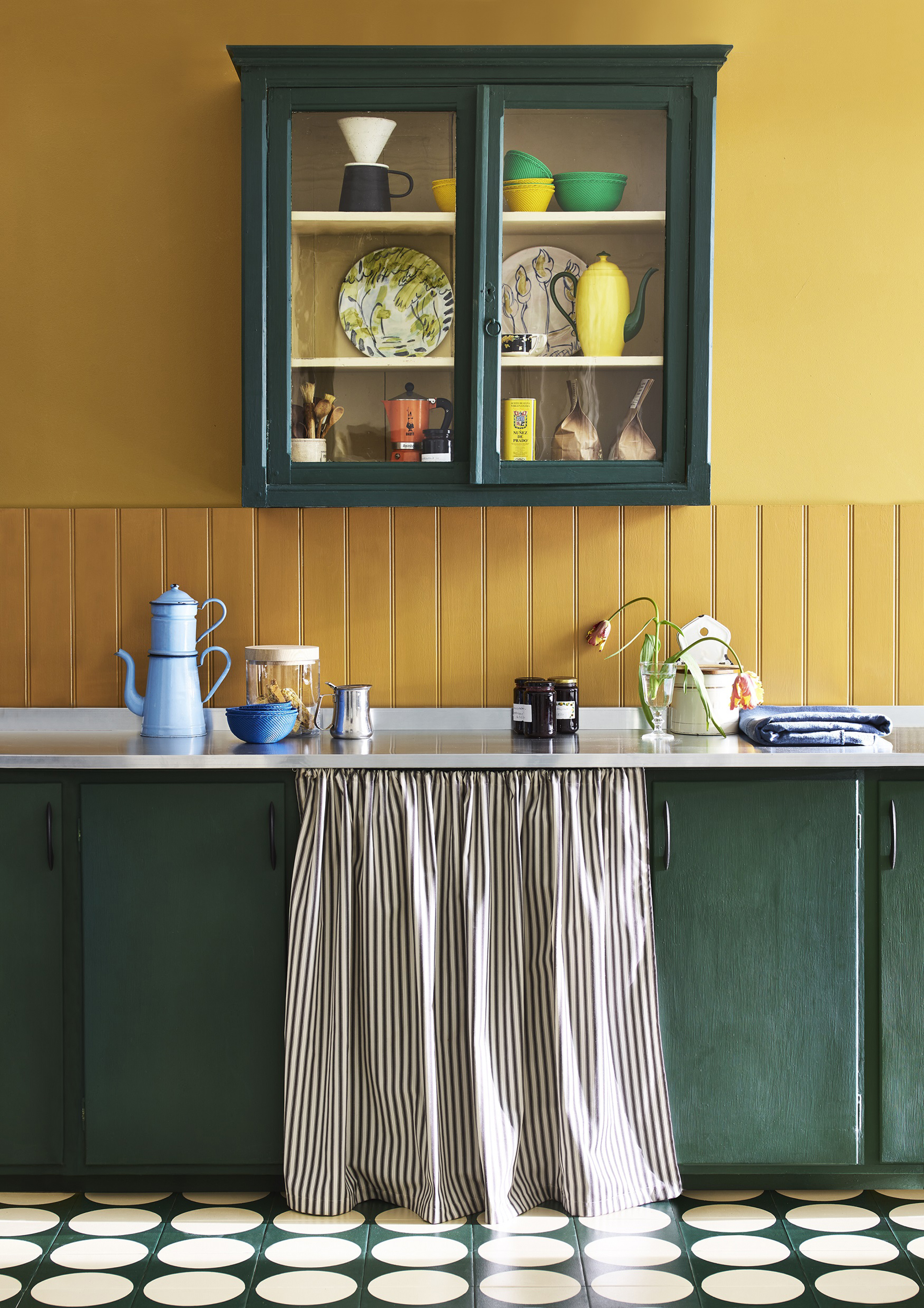 Annie Sloan yellow kitchen with green cabinets and painted tile floor