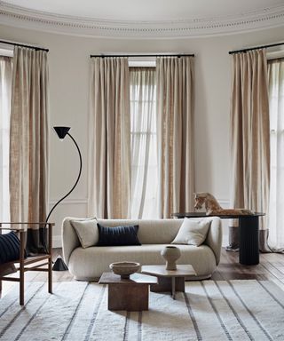 White striped carpet, curved sofa, black curve lamp