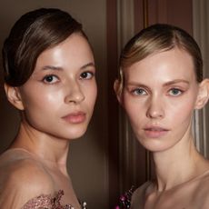 Two models with glowy skin backstage at ziad nakad spring 2025 show