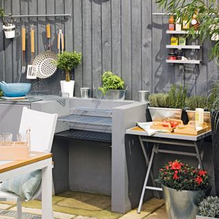 wooden wall with homebase barbecue and garden area