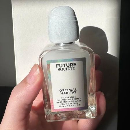 Who What Wear beauty editor Kaitlyn McLintock holding the Future Society Optimal Habitat Fragrance Enhancing Primer.