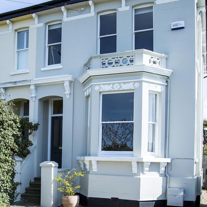 house exterior with blue wall and glass windows