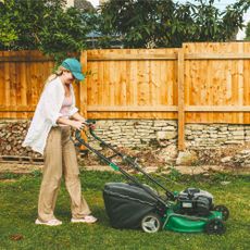woman mowing the lawn