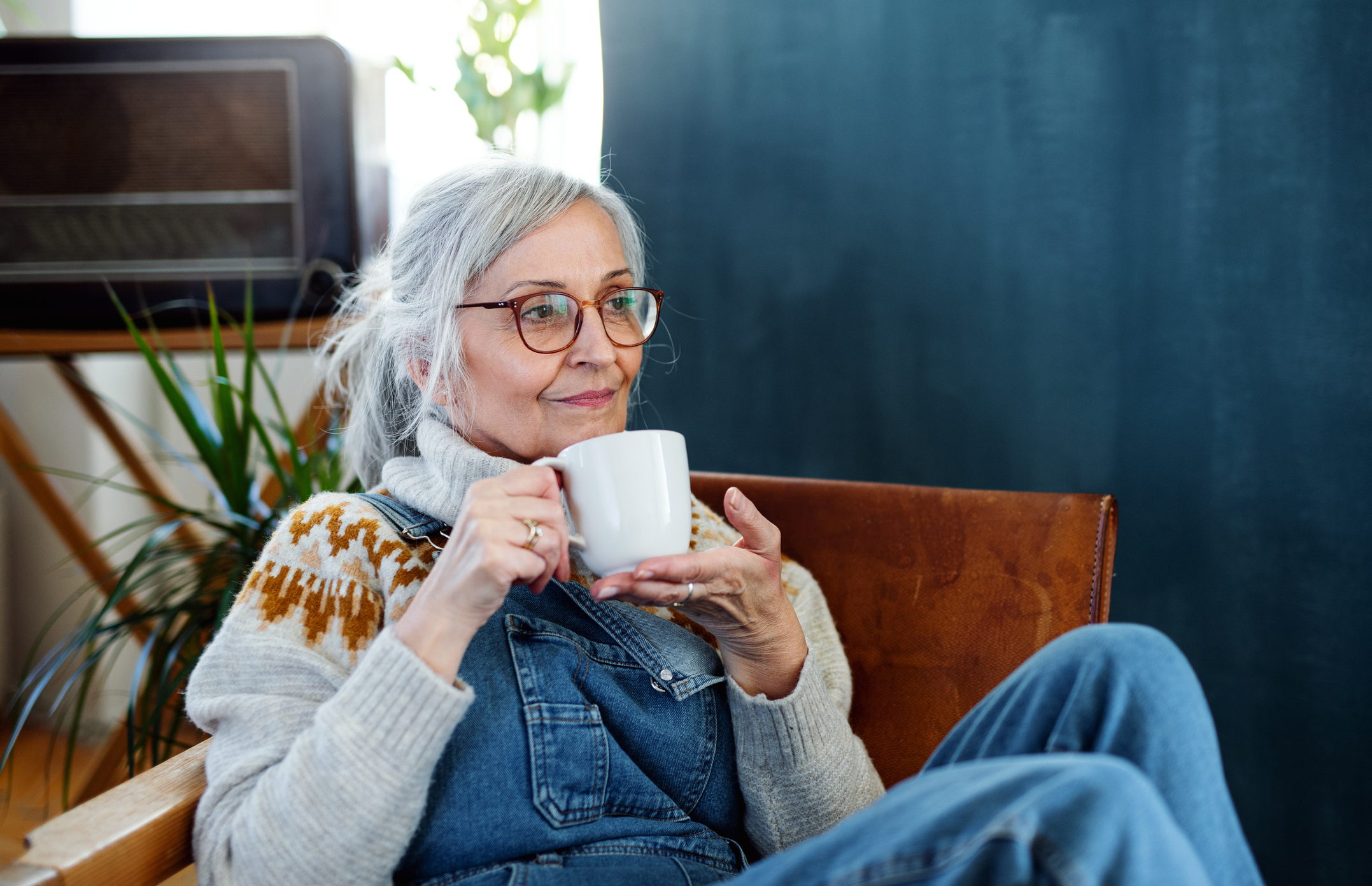Old woman resting on armchair.