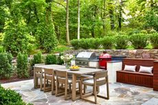 An outdoor kitchen with a large dining space