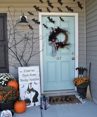 halloween porch with bats wreath and witches decor