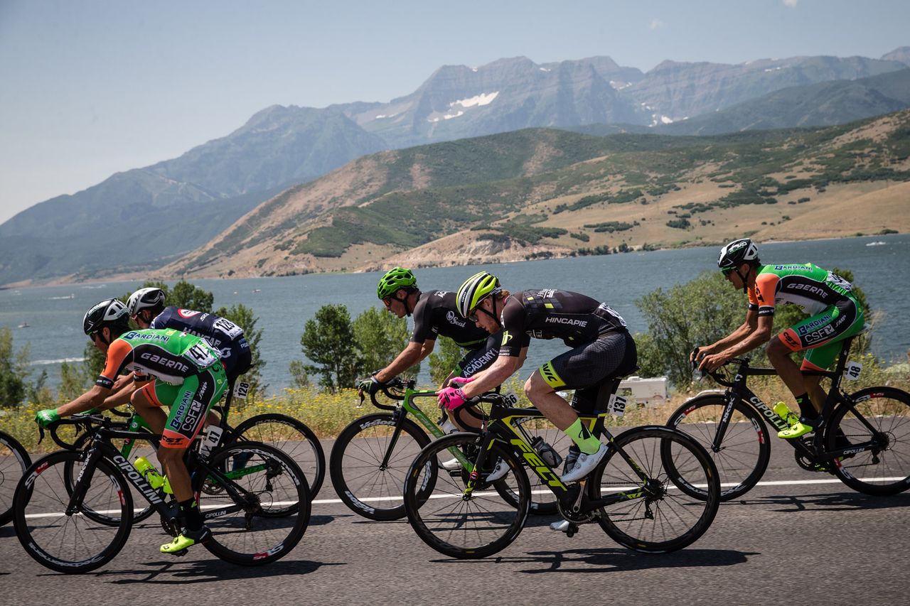 The peloton rides past a lake in the early going of stage 6 in Utah