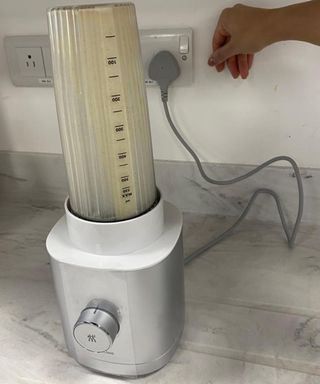 Christina Chrysotomou switching off Zwilling personal blender by the main power source in Reading, UK Future Plc test kitchen