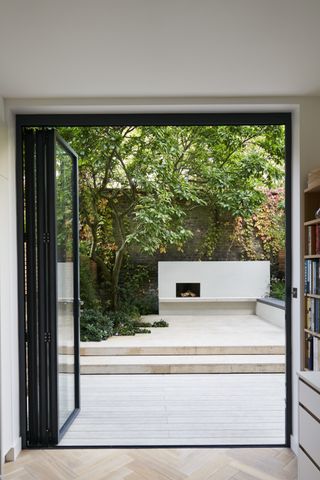 a small deck in a london home's garden