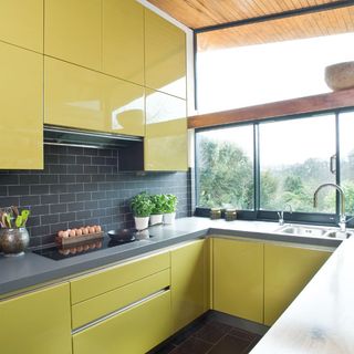 kitchen area with yellow cabinetry and grey surface