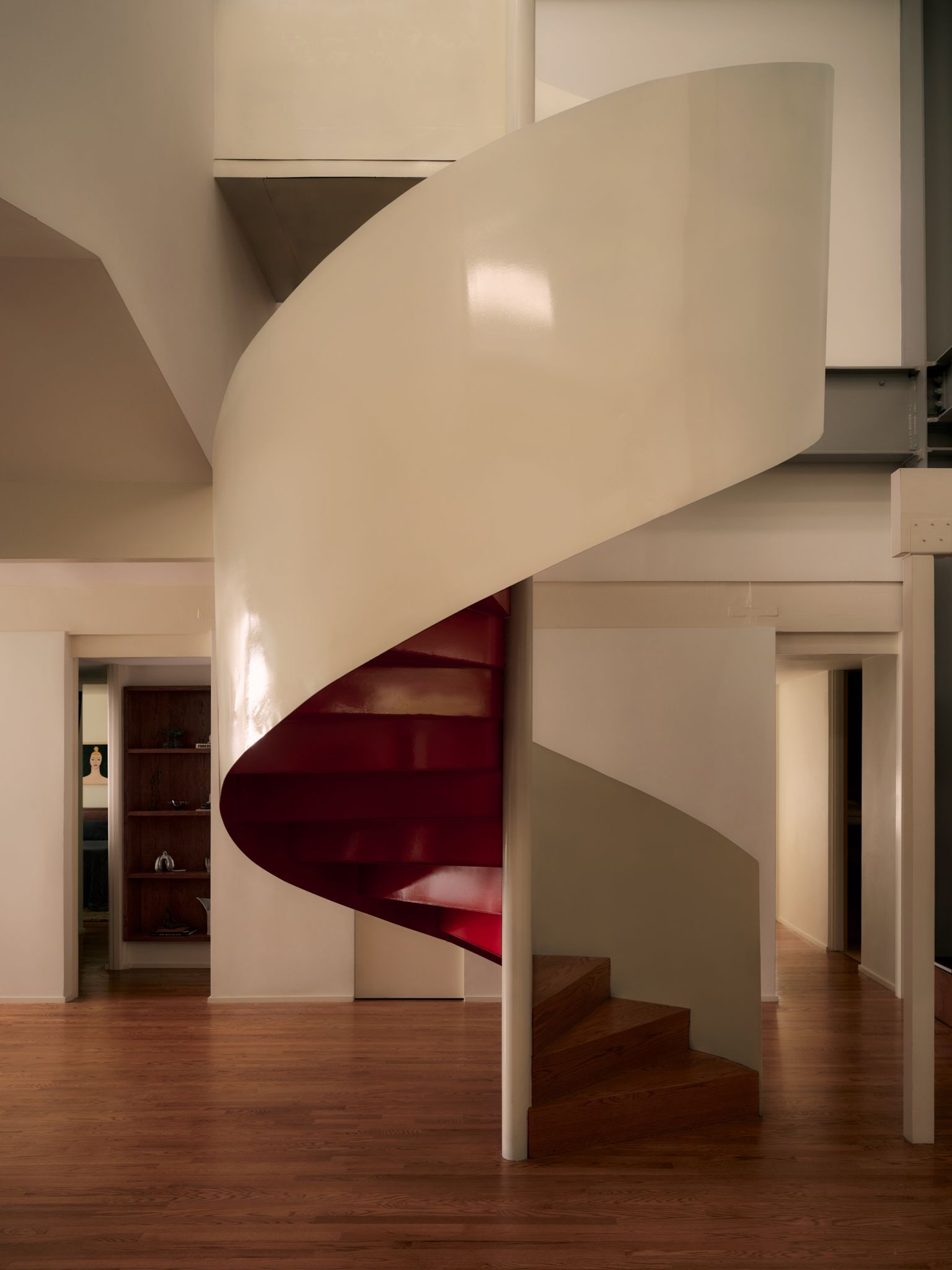 Central white spiral staircase with red underside
