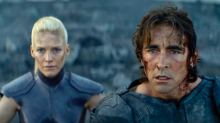 closeup of a man and a woman, both of whom are bloody, disheveled and worried-looking