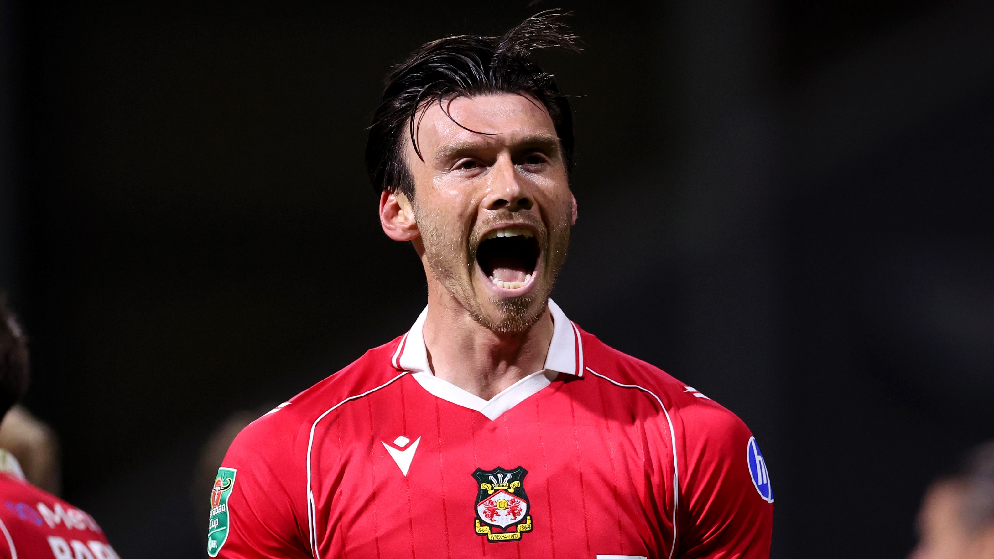 Kieffer Moore of Wrexham celebrates scoring his team's third goal during the Carabao Cup Second Round match between Preston North End and Wrexham at Deepdale on August 26, 2025 in Preston, England.