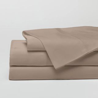 Cozy Earth Bamboo Bed Sheets in Walnut against a gray background. 